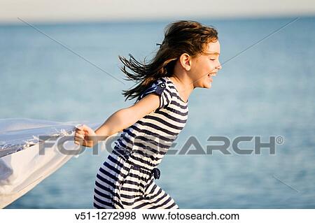 Stock Photo - Girl running on a beach. Fotosearch