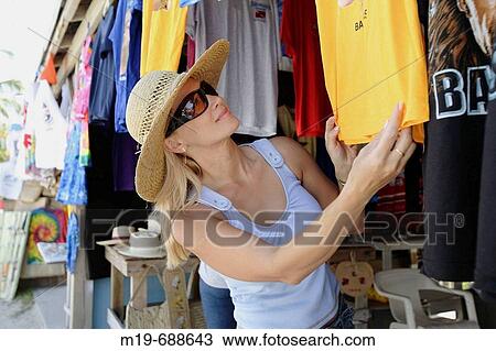 Girl shopping at a flea market View Large Photo Image Stock Image - Girl shopping at a flea market. Fotosearch