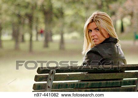 Girl sitting in a park in Milan, watching. View Large Photo Image Stock Image - Girl sitting in a park in Milan, watching.. Fotosearch