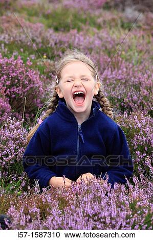girl sitting in blooming heather field View Large Photo Image Stock Image - girl sitting in blooming heather field. Fotosearch