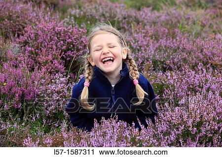 girl sitting in blooming heather field View Large Photo Image Stock Image - girl sitting in blooming heather field. Fotosearch