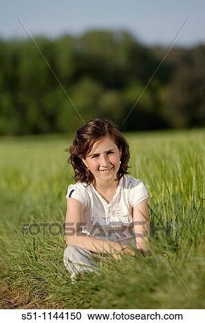Girl sitting in the field View Large Photo Image Stock Image - Girl sitting in the field. Fotosearch
