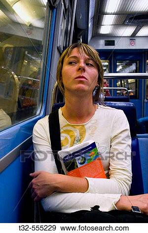 Stock Photo - girl sitting in the metro. Fotosearch