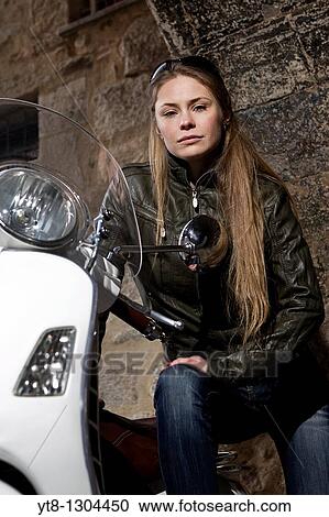 Girl sitting on a motor scooter View Large Photo Image Stock Image - Girl sitting on a motor scooter. Fotosearch