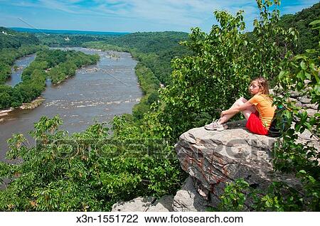 Girl sitting on a rock overlooking Potomic River, Burkitts, MD View Large Photo Image Stock Image - Girl sitting on a rock overlooking Potomic River, Burkitts, MD. Fotosearch