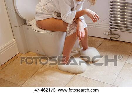 Girl sitting on the toilet with pants round her ankles View Large Photo Image Stock Image - Girl sitting on the toilet with pants round her ankles. Fotosearch