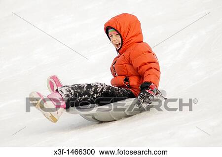 Girl sliding down a city park hill in the winter age 7 St Paul Minnesota MN USA View Large Photo Image Stock Image - Girl sliding down a city park hill in the winter age 7 St Paul Minnesota MN USA. Fotosearch