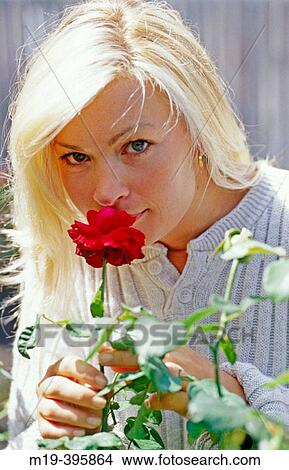 girl smelling a flower View Large Photo Image Picture - girl smelling a flower. Fotosearch