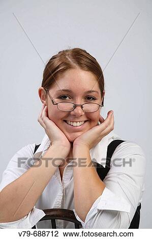 Girl smiling with glasses perched on her nose View Large Photo Image Stock Image - Girl smiling with glasses perched on her nose. Fotosearch