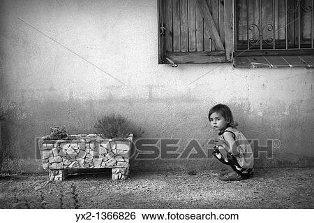 Stock Photograph - Girl squatting and waiting. Fotosearch