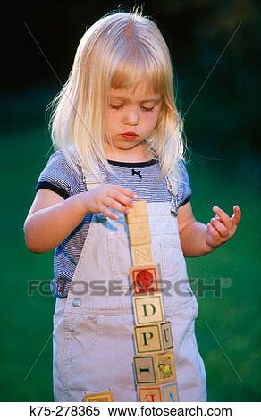 Girl stacking up building blocks View Large Photo Image Stock Photography - Girl stacking up building blocks. Fotosearch