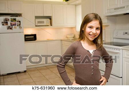 Girl standing in kitchen. View Large Photo Image Stock Image - Girl standing in kitchen.. Fotosearch
