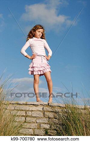 Girl standing on wall. Tarifa, Cadiz province, Andalusia, Spain View Large Photo Image Stock Image - Girl standing on wall. Tarifa, Cadiz province, Andalusia, Spain. Fotosearch