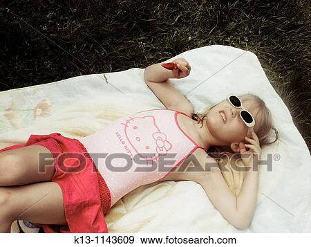 Girl sunbathing View Large Photo Image Stock Photo - Girl sunbathing. Fotosearch