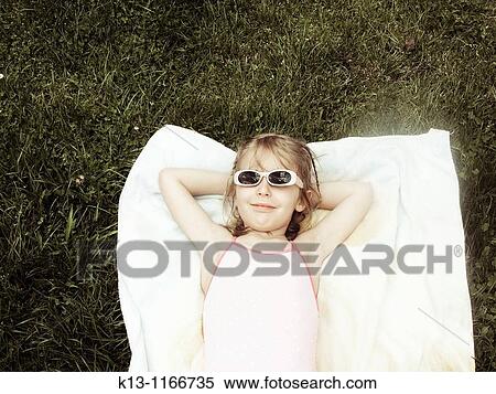 Stock Photography - Girl sunbathing. Fotosearch