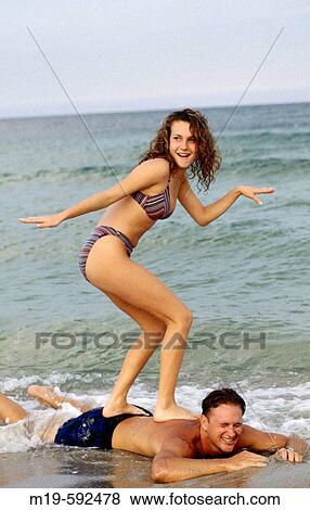 girl? surfing? on a boys back. View Large Photo Image Stock Photo - girl? surfing? on a boys back.. Fotosearch