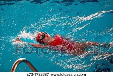 Girl swimming backstroke in pool View Large Photo Image Stock Photo - Girl swimming backstroke in pool. Fotosearch