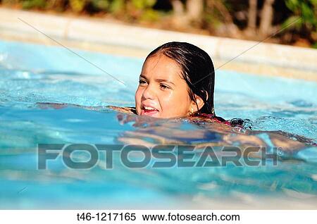 Stock Photography - Girl swimming in a pool. Fotosearch