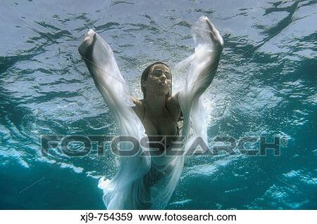 Stock Photo - Girl swimming underwater: underwater angel.. Fotosearch