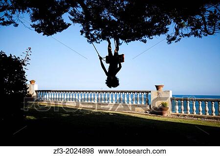 Girl swinging in the garden of her home, in Vilanova i la Geltr, Barcelona. Spain View Large Photo Image Stock Photo - Girl swinging in the garden of her home, in Vilanova i la Geltr, Barcelona. Spain. Fotosearch