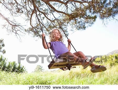 Stock Image - girl swinging. Fotosearch
