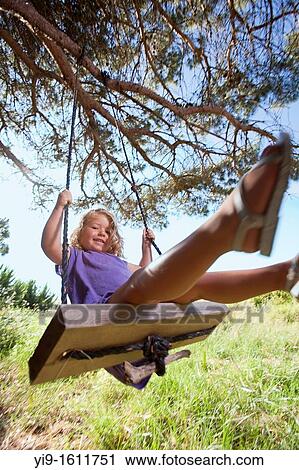 Stock Image - girl swinging. Fotosearch