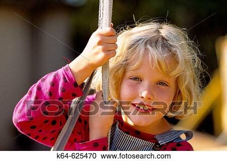 Girl swings and smiling View Large Photo Image Stock Image - Girl swings and smiling. Fotosearch