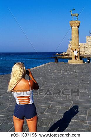 Girl Takind pictures to stag column Mandraki Harbour Rhodes City, Rhodes Island, Greece. View Large Photo Image Stock Photograph - Girl Takind pictures to stag column Mandraki Harbour Rhodes City, Rhodes Island, Greece.. Fotosearch