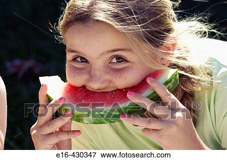 Girl taking big bite of watermelon View Large Photo Image Stock Photo - Girl taking big bite of watermelon. Fotosearch