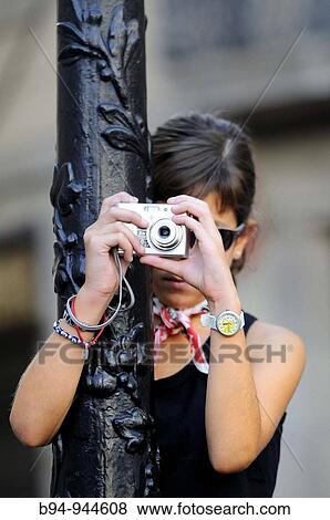 Stock Photo - Girl taking pictures in Pla? a Sant Jaume, La Merce feast, Barcelona, Catalonia, Spain. Fotosearch