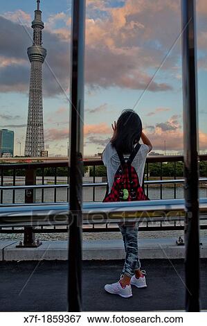 Girl taking pictures Sky Tree from Sumidagawa river, Asakusa District, Tokyo, Japan View Large Photo Image Stock Photo - Girl taking pictures Sky Tree from Sumidagawa river, Asakusa District, Tokyo, Japan. Fotosearch