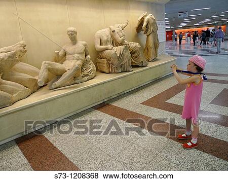 Girl taking pictures to Athens subway scultures, Athens, Greece View Large Photo Image Stock Photo - Girl taking pictures to Athens subway scultures, Athens, Greece. Fotosearch