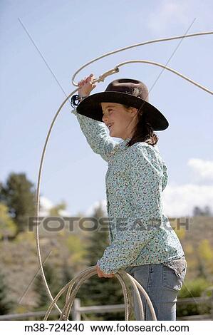 Girl throwing a lasso, Lone Mt Ranch, Big Sky, Montana, USA View Large Photo Image Stock Image - Girl throwing a lasso, Lone Mt Ranch, Big Sky, Montana, USA. Fotosearch