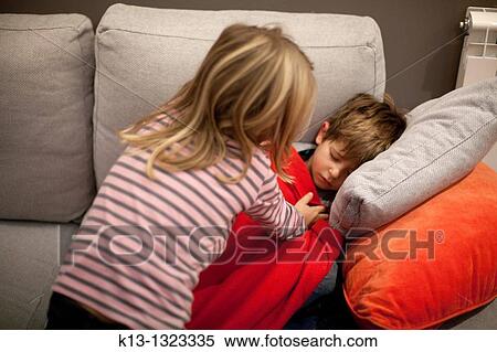 Girl tucking her brother View Large Photo Image Stock Photography - Girl tucking her brother. Fotosearch