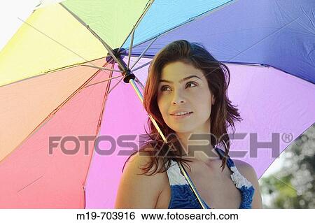 Girl under an umbrella View Large Photo Image Stock Photograph - Girl under an umbrella. Fotosearch