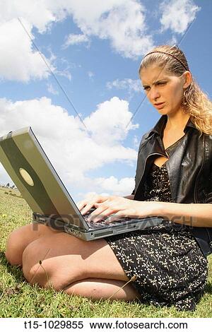 girl using a laptop in a park View Large Photo Image Stock Photography - girl using a laptop in a park. Fotosearch