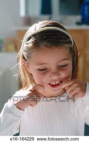 Girl using dental floss View Large Photo Image Stock Photo - Girl using dental floss. Fotosearch