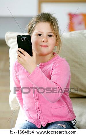 Girl using smartphone View Large Photo Image Picture - Girl using smartphone. Fotosearch