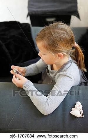 Girl using smartphone View Large Photo Image Picture - Girl using smartphone. Fotosearch