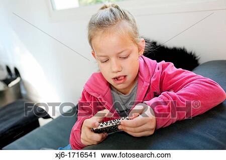 Stock Image - Girl using smartphone. Fotosearch