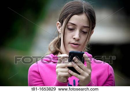 Girl using smartphone View Large Photo Image Stock Photo - Girl using smartphone. Fotosearch