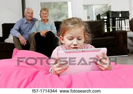 Picture - Girl using tablet computer. Fotosearch
