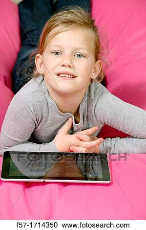 Girl using tablet computer View Large Photo Image Stock Image - Girl using tablet computer. Fotosearch