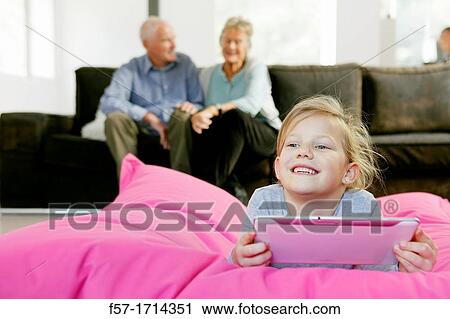 Girl using tablet computer View Large Photo Image Stock Image - Girl using tablet computer. Fotosearch