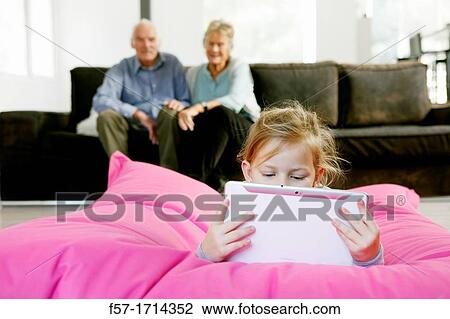 Girl using tablet computer View Large Photo Image Stock Image - Girl using tablet computer. Fotosearch