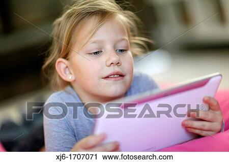 Girl using tablet computer View Large Photo Image Stock Image - Girl using tablet computer. Fotosearch