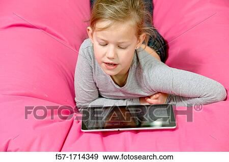 Stock Photo - Girl using tablet computer. Fotosearch