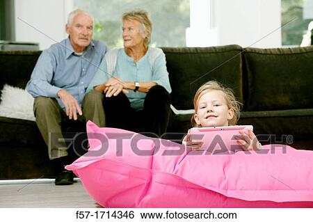 Girl using tablet computer View Large Photo Image Stock Photograph - Girl using tablet computer. Fotosearch
