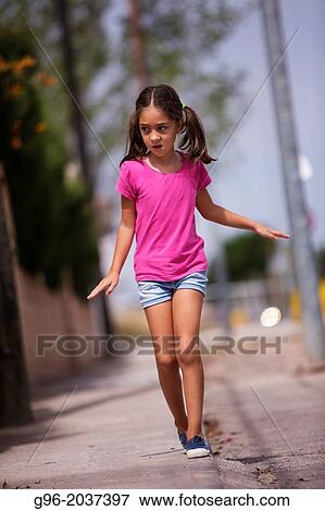 girl walking along the pavement. View Large Photo Image Stock Photo - girl walking along the pavement.. Fotosearch