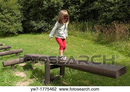 Girl walking on balance beam View Large Photo Image Stock Image - Girl walking on balance beam. Fotosearch